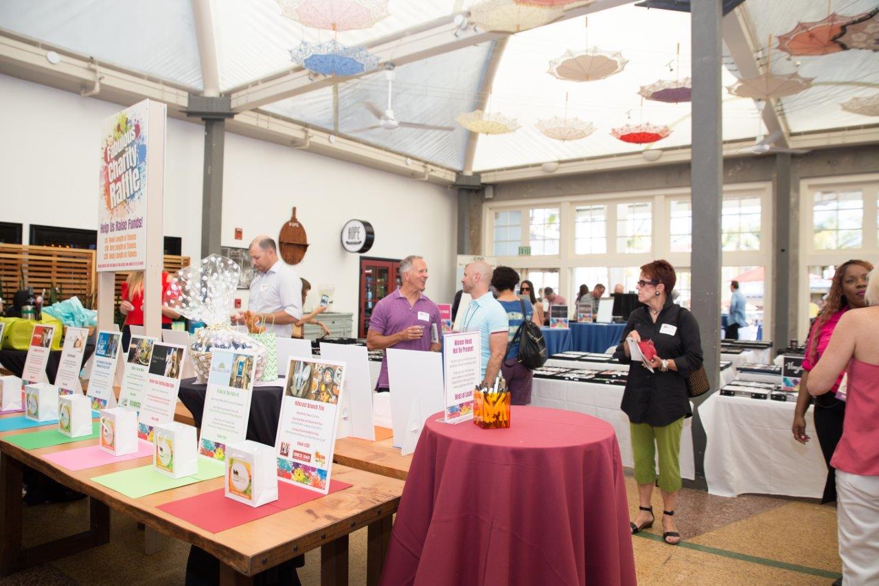 People looking at gift bags at Raise Your Glasses 2018 Event