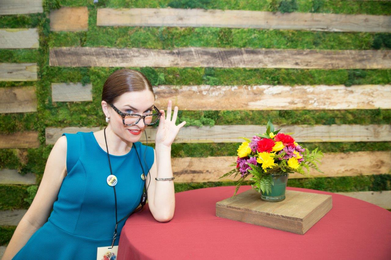 Woman sitting at table at Raise Your Glasses 2018 Event