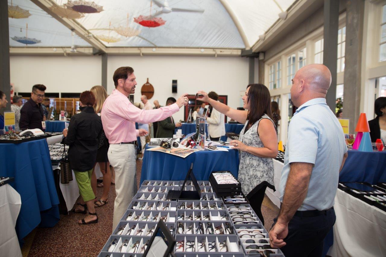 Vendor and guest chatting at Raise Your Glasses 2018 Event