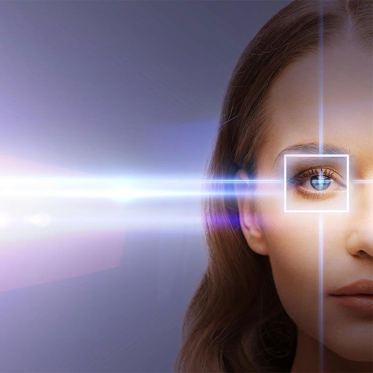 Woman with a laser surgery target and laser beam surrounding her eye