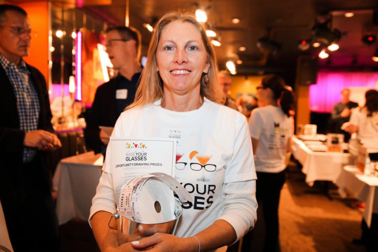 Woman in colorful t-shirt at Raise Your Glasses event