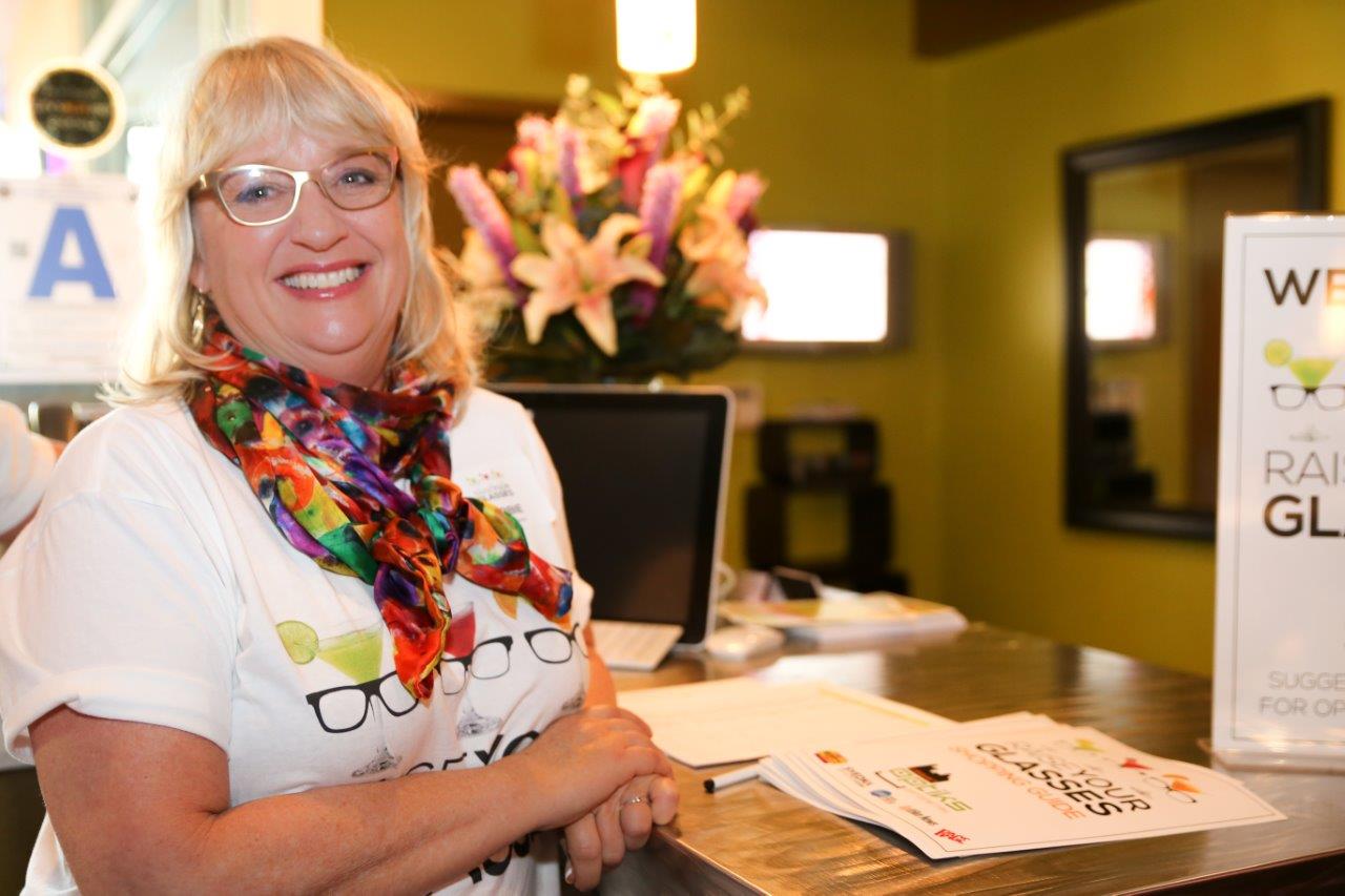 Woman with colorful t-shirt and scarf at Raise Your Glasses event