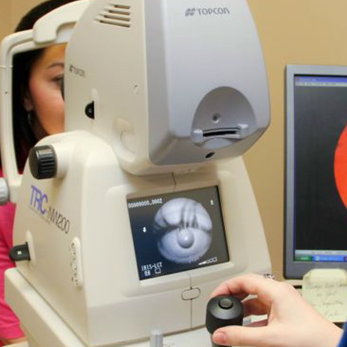 Person in eye exam undergoing digital retinal imaging