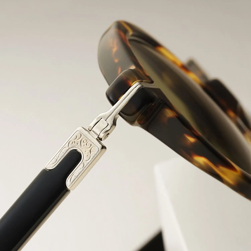 A close up of a pair of matsuda sunglasses on a white surface