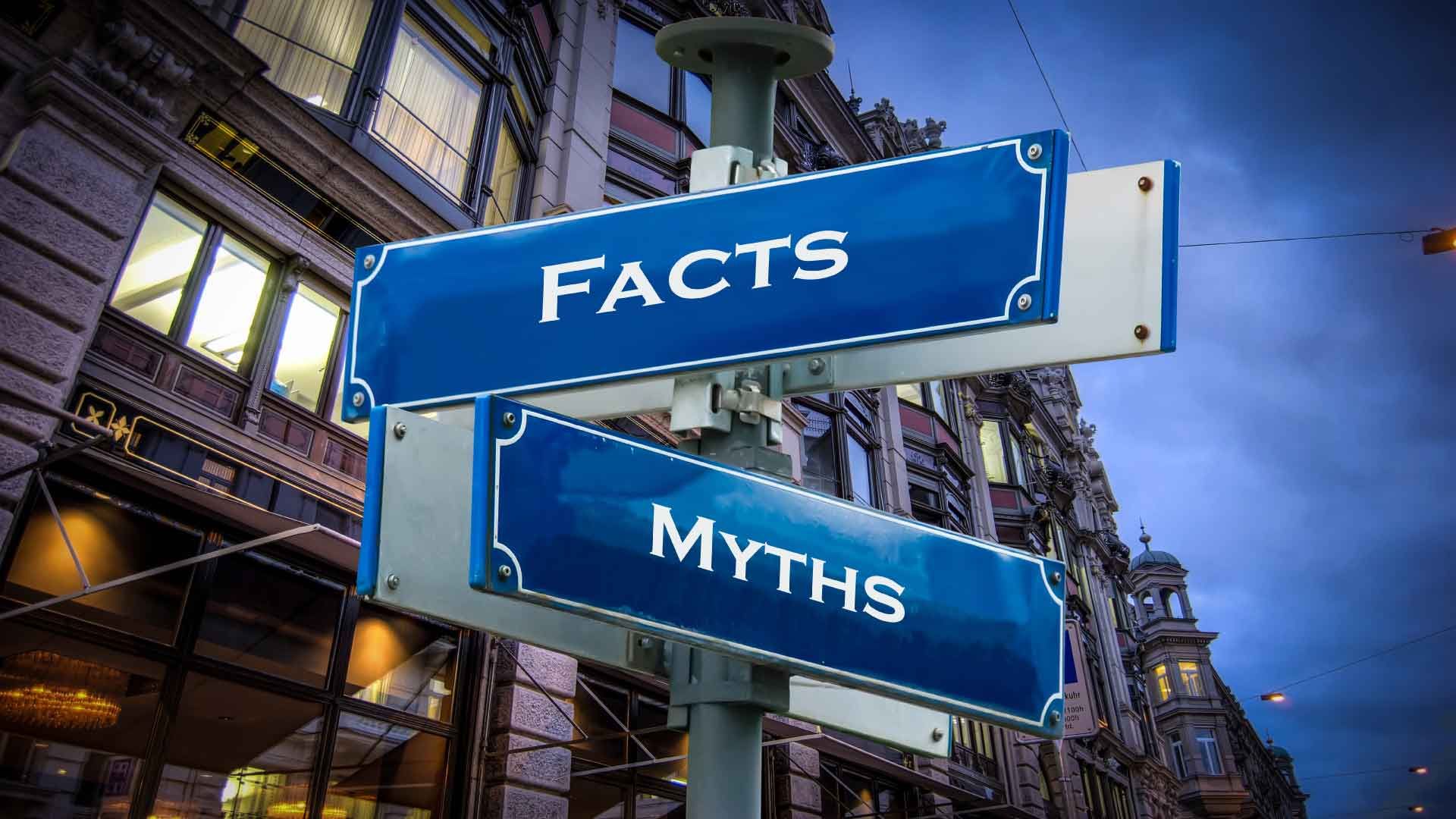 Blue street signs reading facts and myth