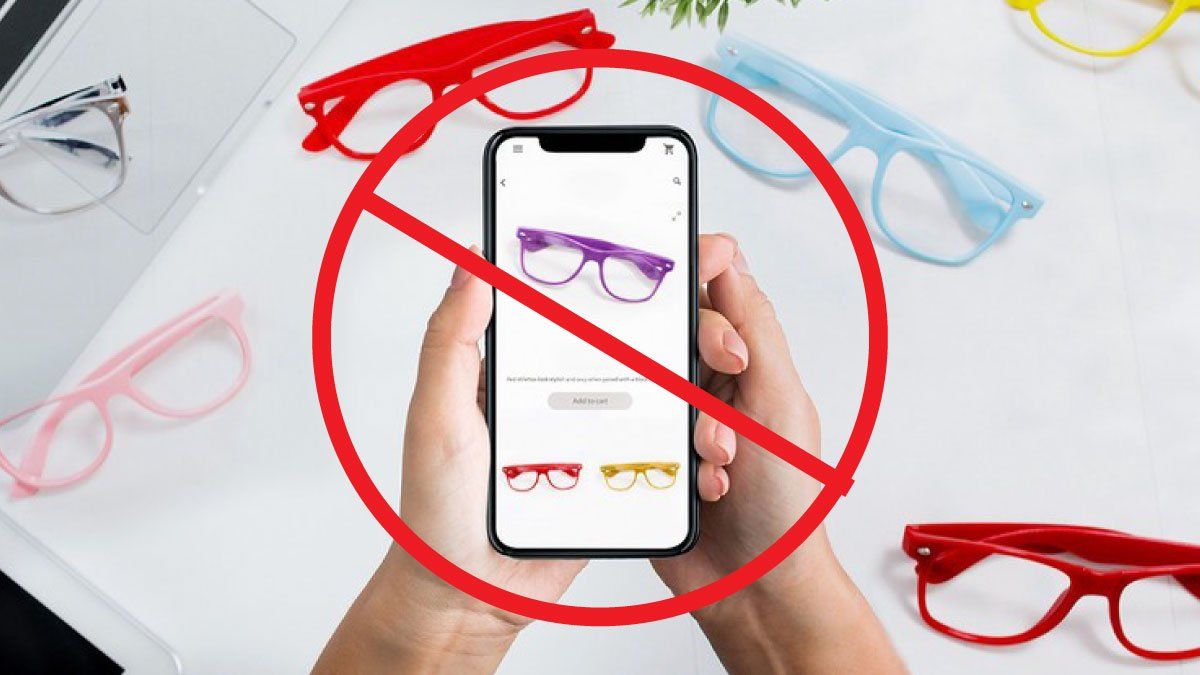 Red warning icon over cell phone with eyeglasses on it and frames in background