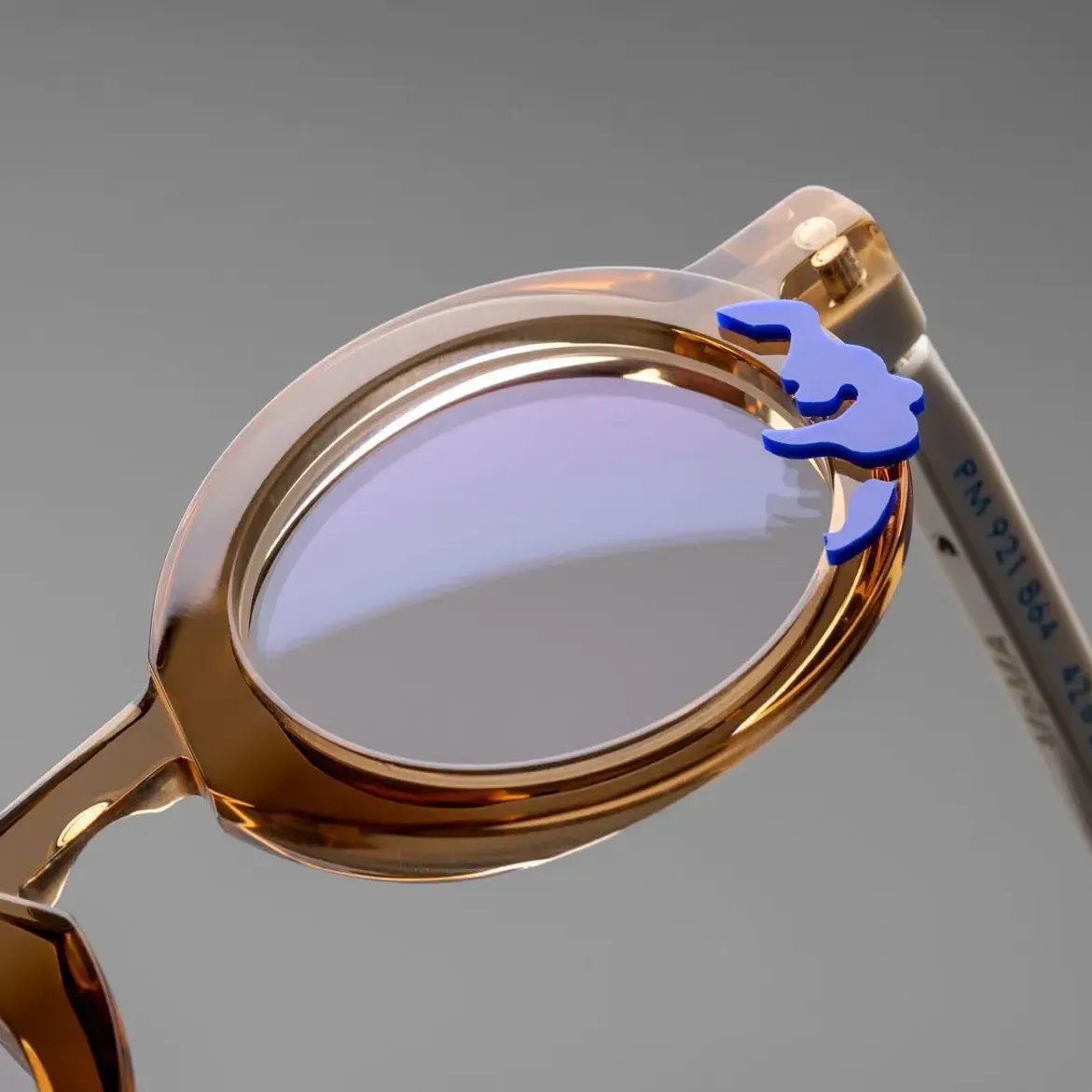 A brown pair of glasses with a purple embelishment representing a splash of water