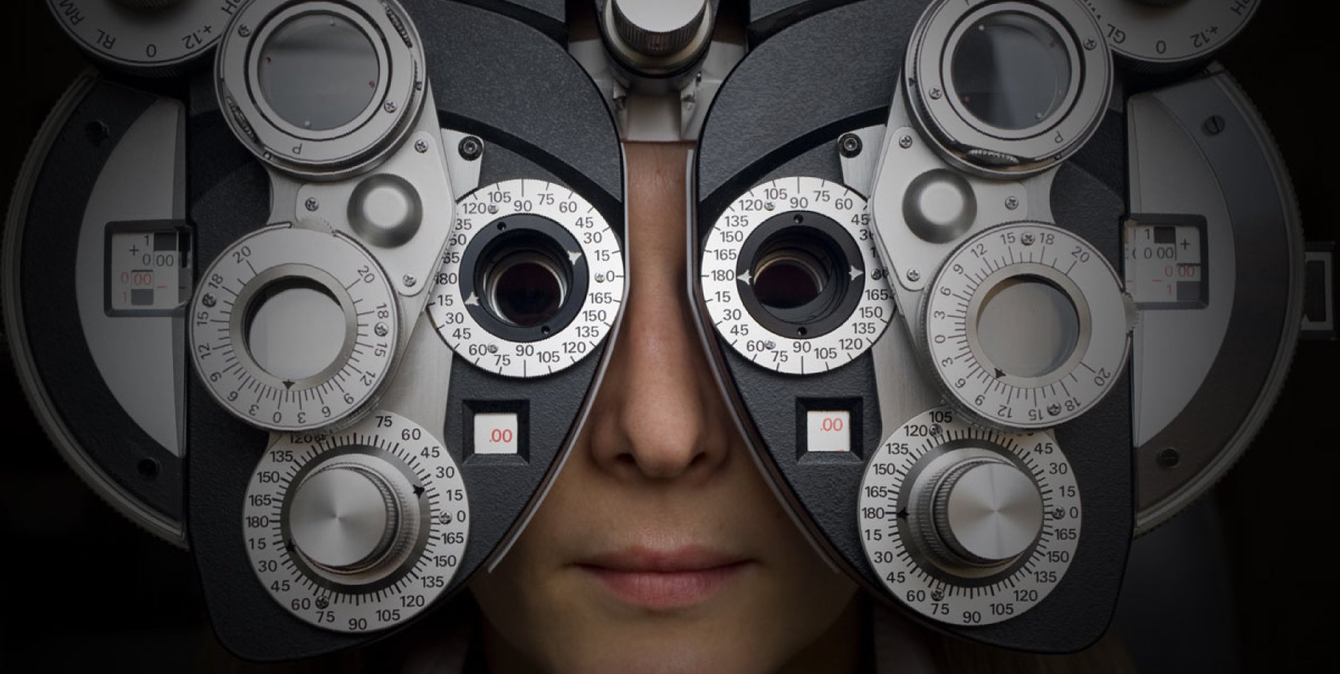 Close up of a person looking through optometric device