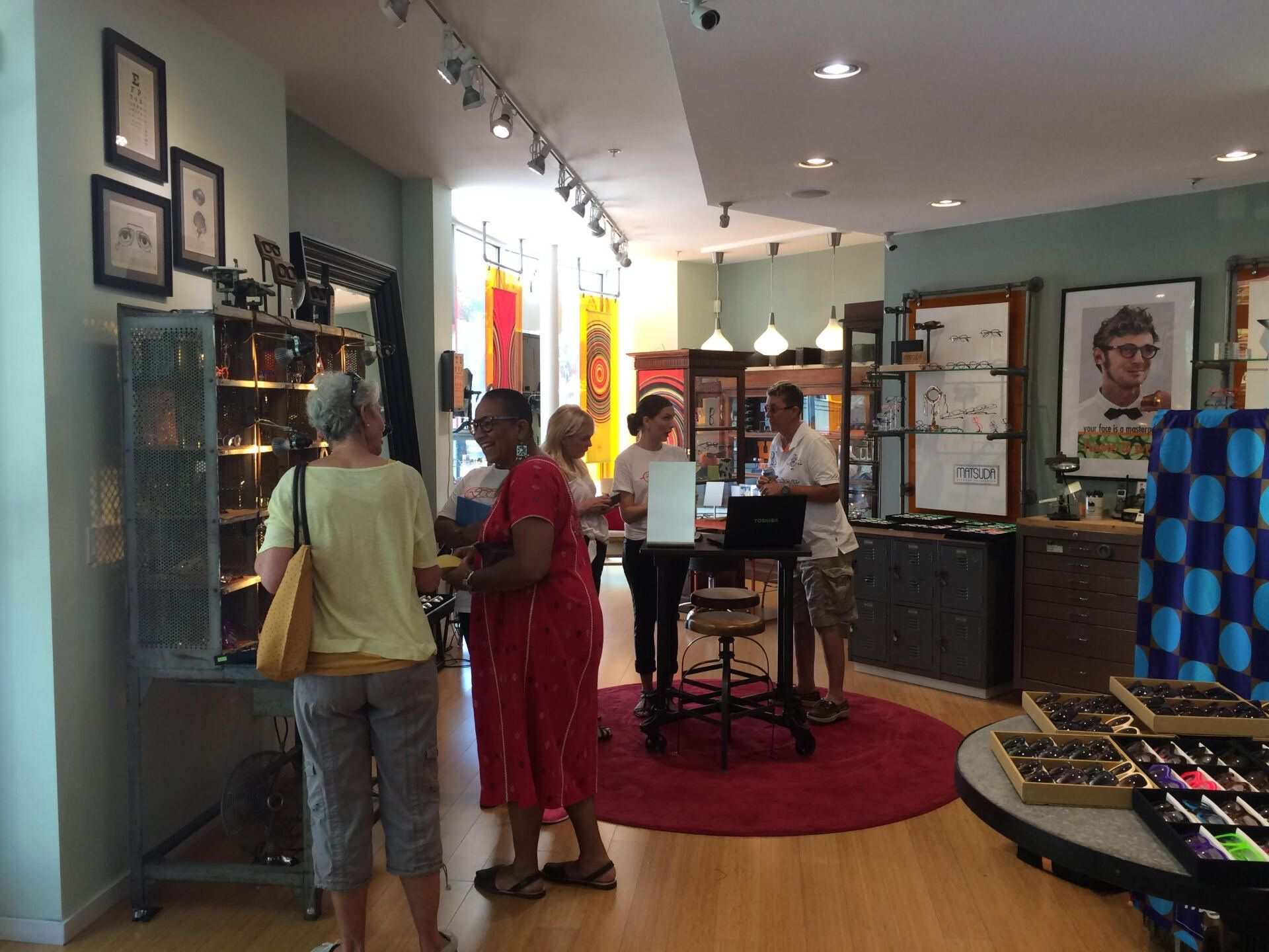 Many guests standing inside Urban Optiks Optometry at 2016 Theo Trunk Show