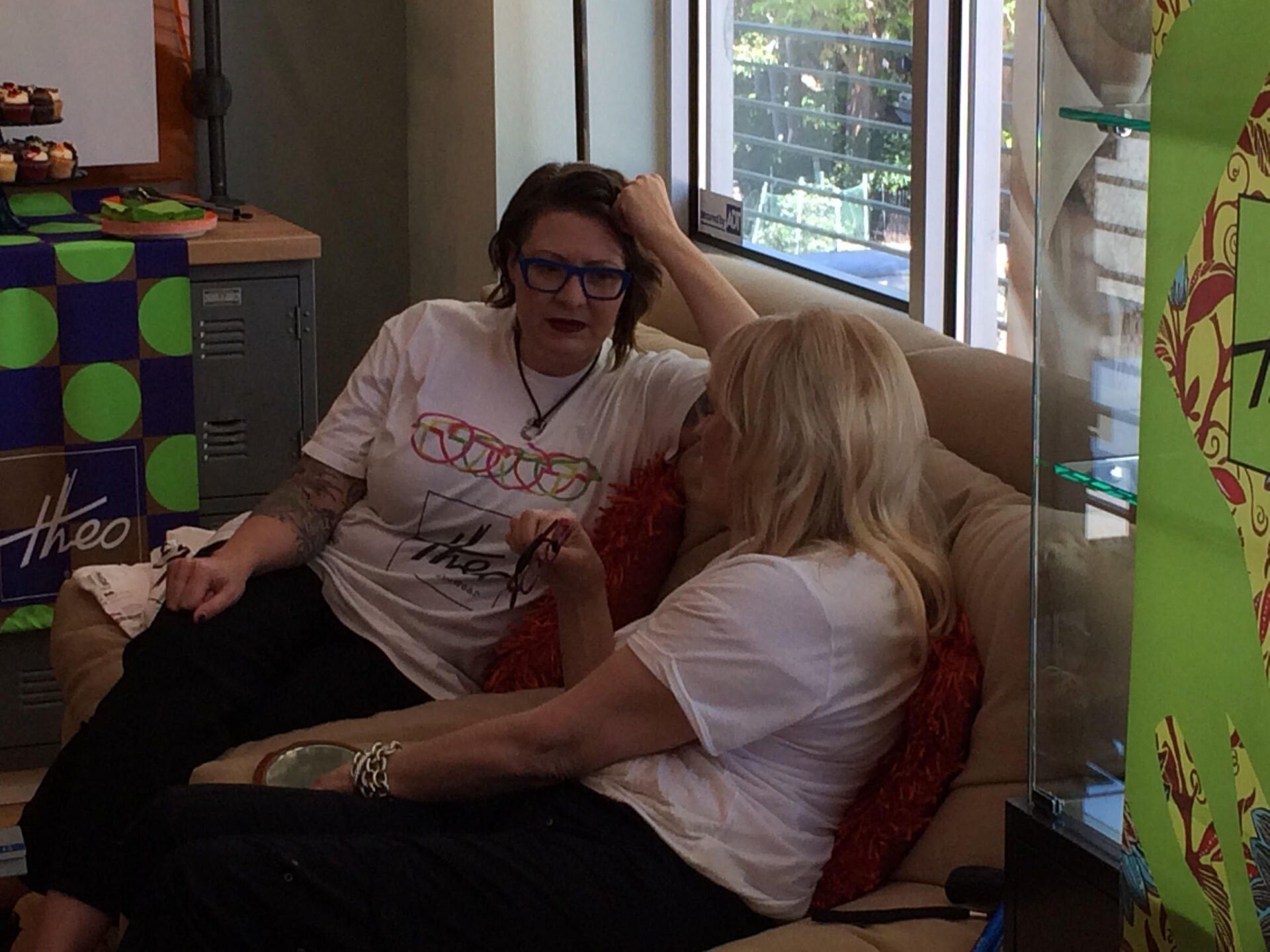 2 people sitting on couch at 2016 Theo Trunk Show Event