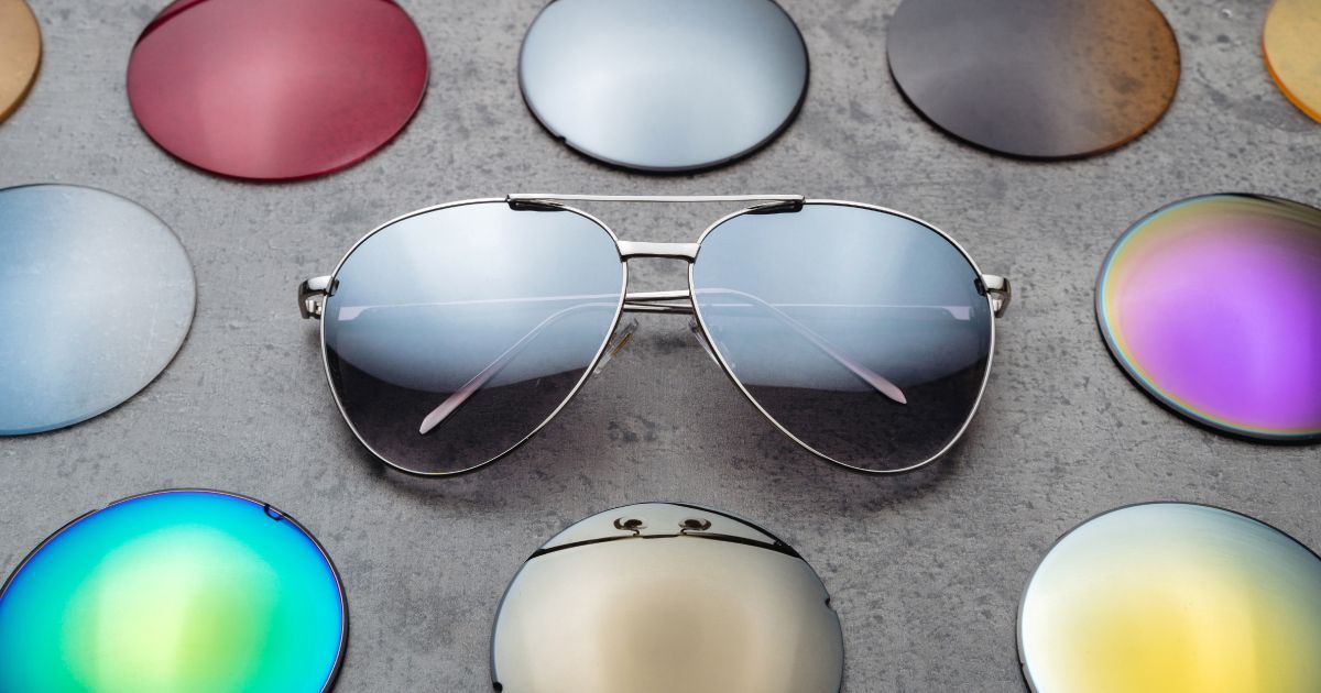 A pair of sunglasses surrounded by different colored lenses.