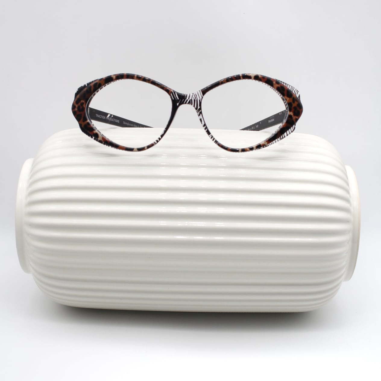 Traction Productions eyeglass frame on white decorative object