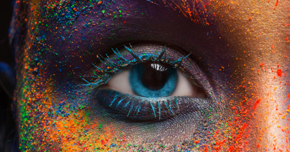 An eye with different colors of makeup around it
