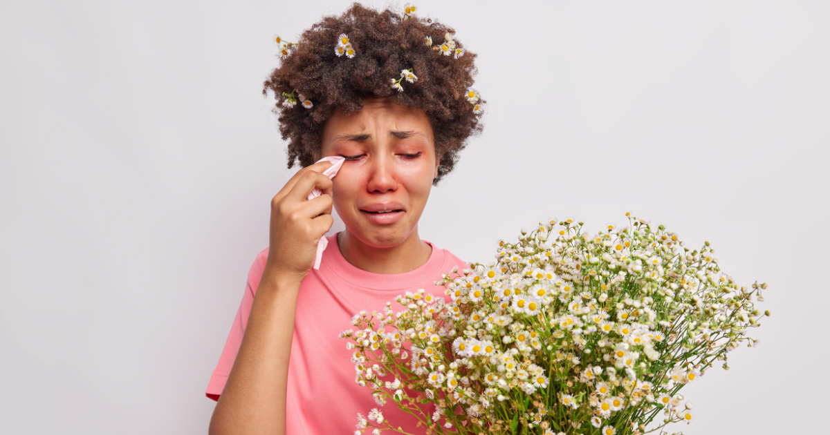 Curly haired person dealing with challenging seasonal allergic conjunctivitis
