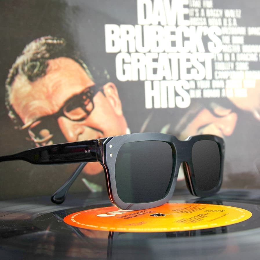 A pair of sunglasses sits on a record labeled dave brubeck 's greatest hits