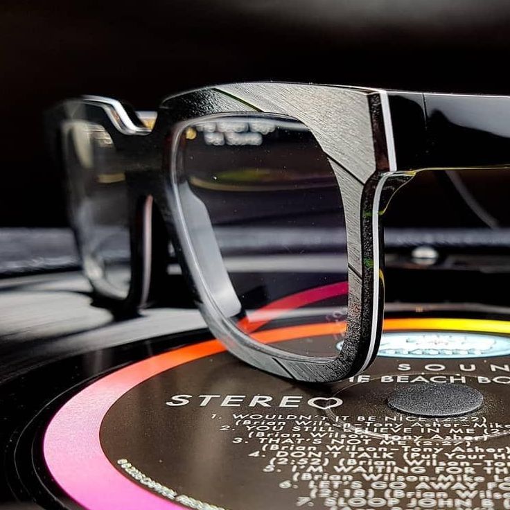A pair of Vinylize glasses sitting on top of a record