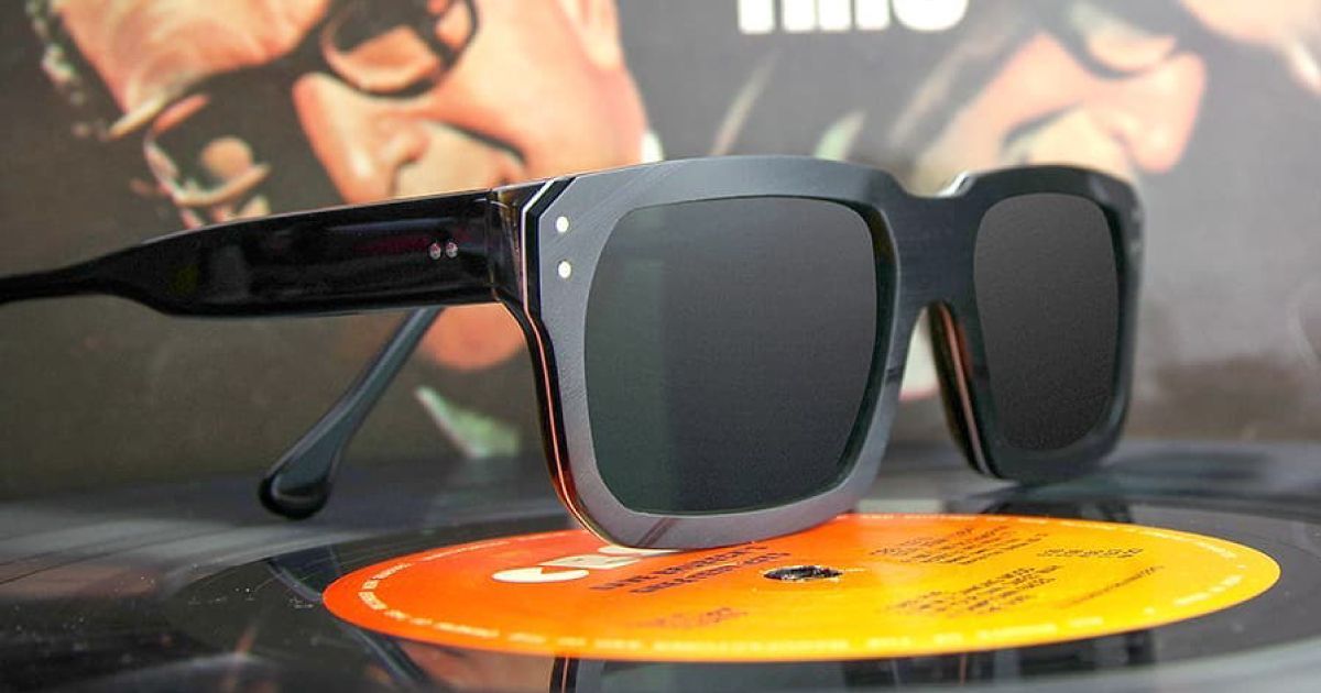A pair of Vinylize sunglasses sitting on top of a record