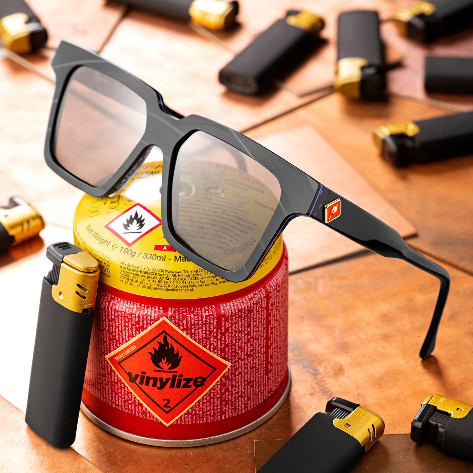 Vinylize sunglass sitting on a colorful metal can