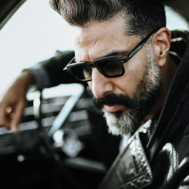 Bearded guy wearing a leather jacket and black Vinylize Sunglasses