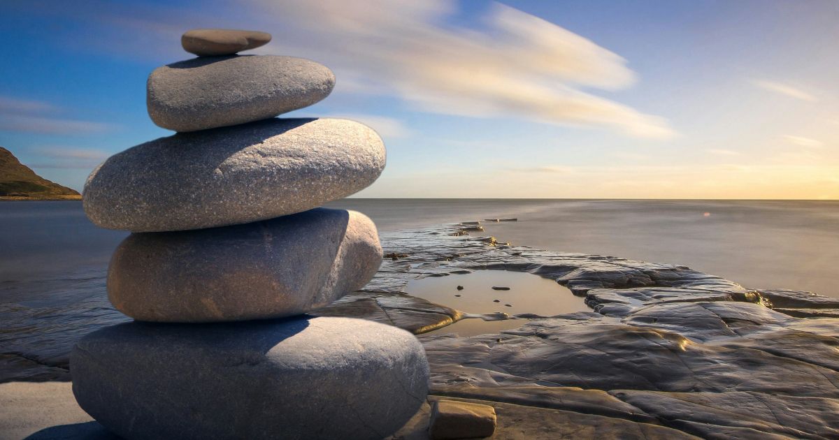 A pile of rocks stacked on top of each other on a beach .