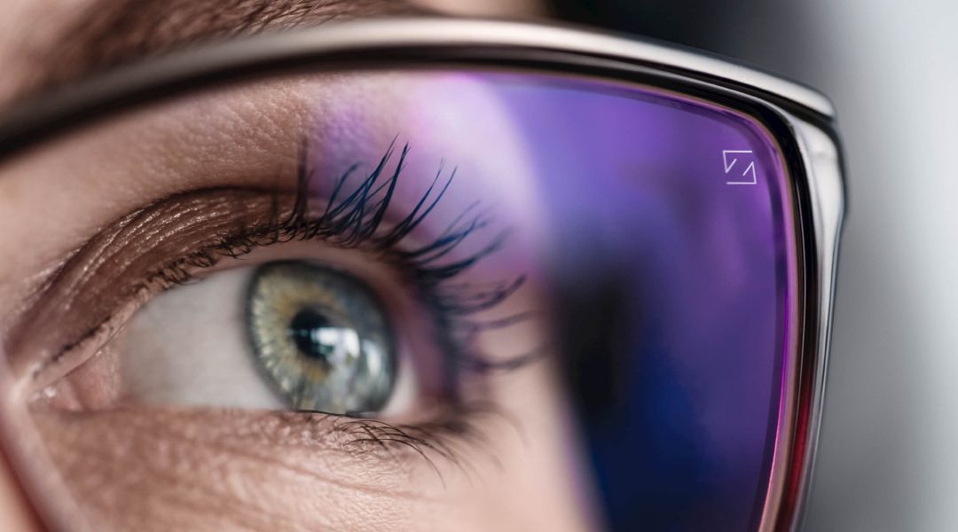 Close up of a person eye looking through an eyeglass lens