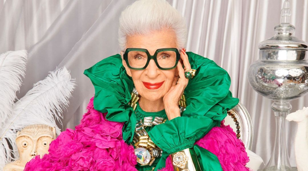 Fashion icon Iris Apfel wearing a green oversized frame