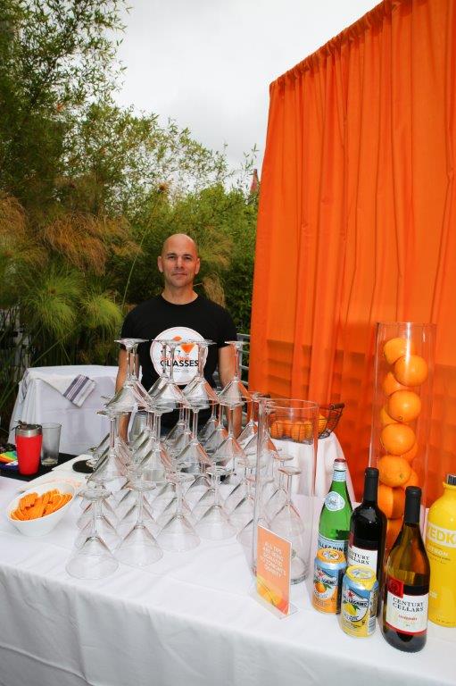 Person standing outside at drinks table at Raise Your Glasses 2017 Event