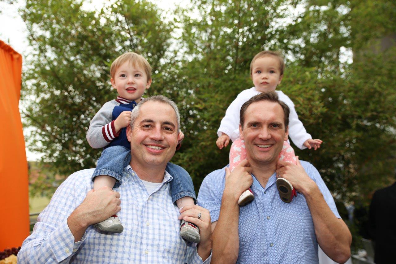 2 men with babies on their shoulders at Raise Your Glasses 2017