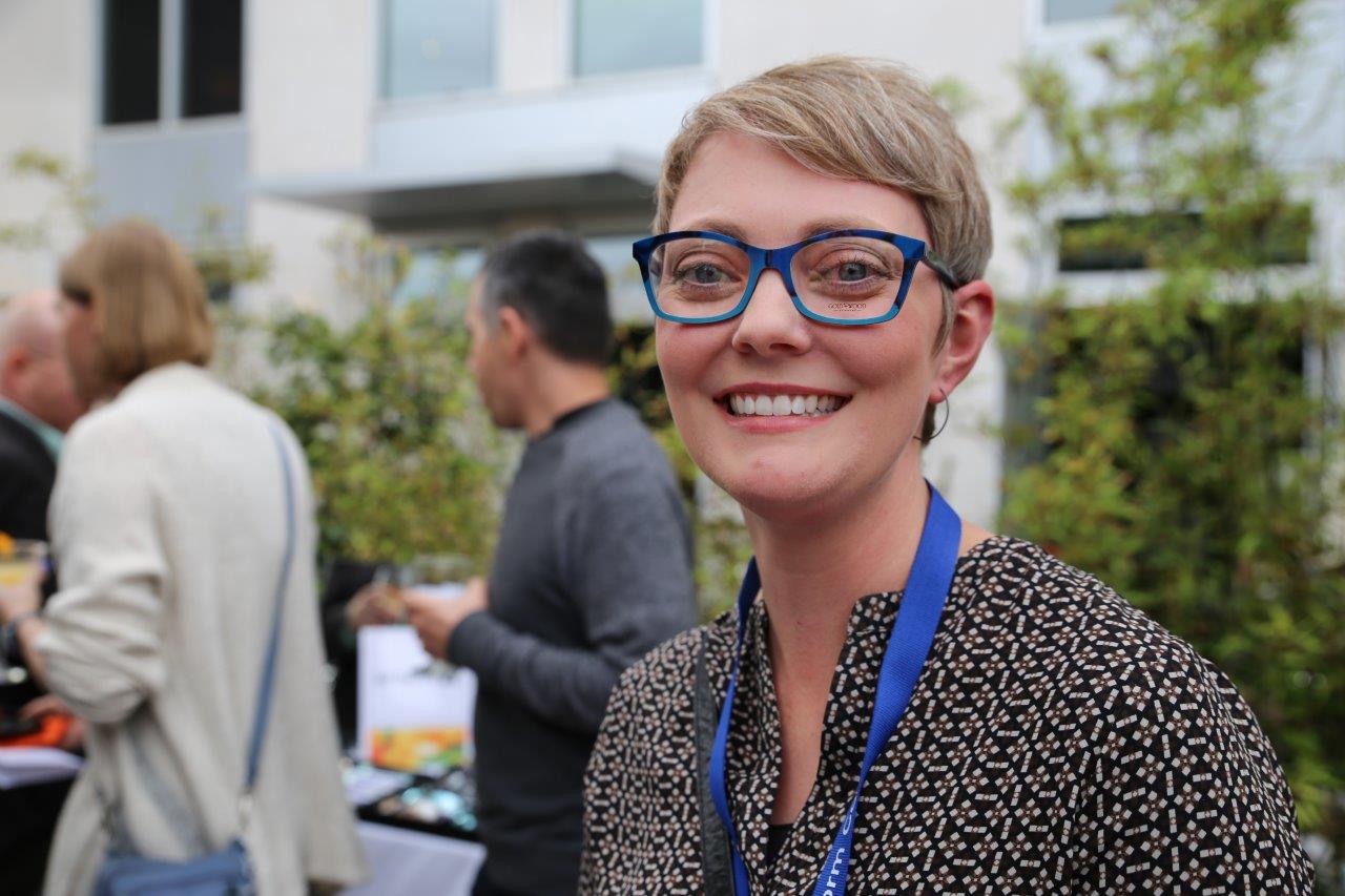 Woman modeling blue frames at Raise Your Glasses 2017