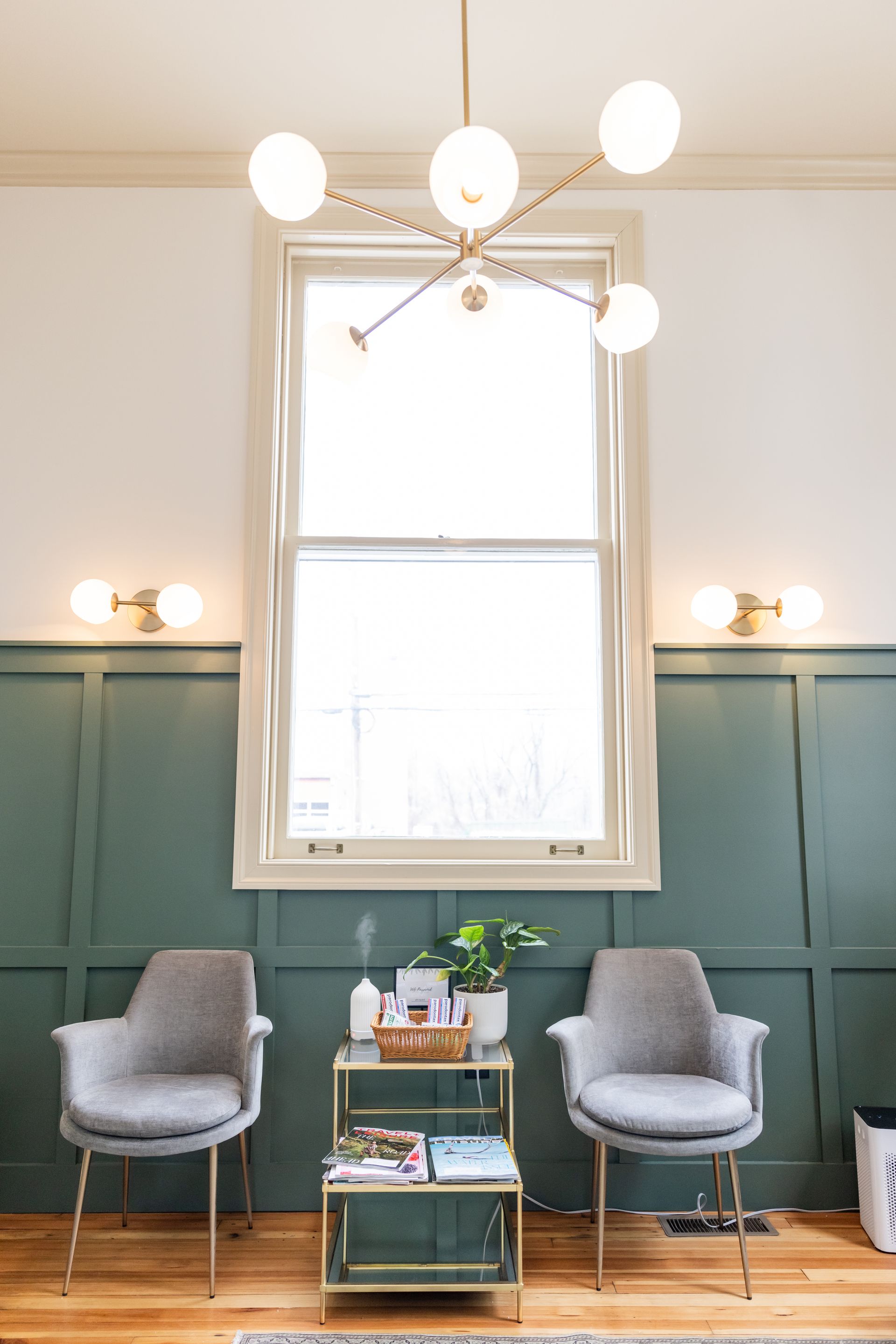 A waiting room with two chairs and a window.