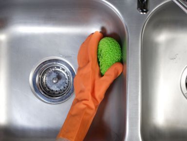 Our commercial cleaning team scrubbing a sink in Guildford