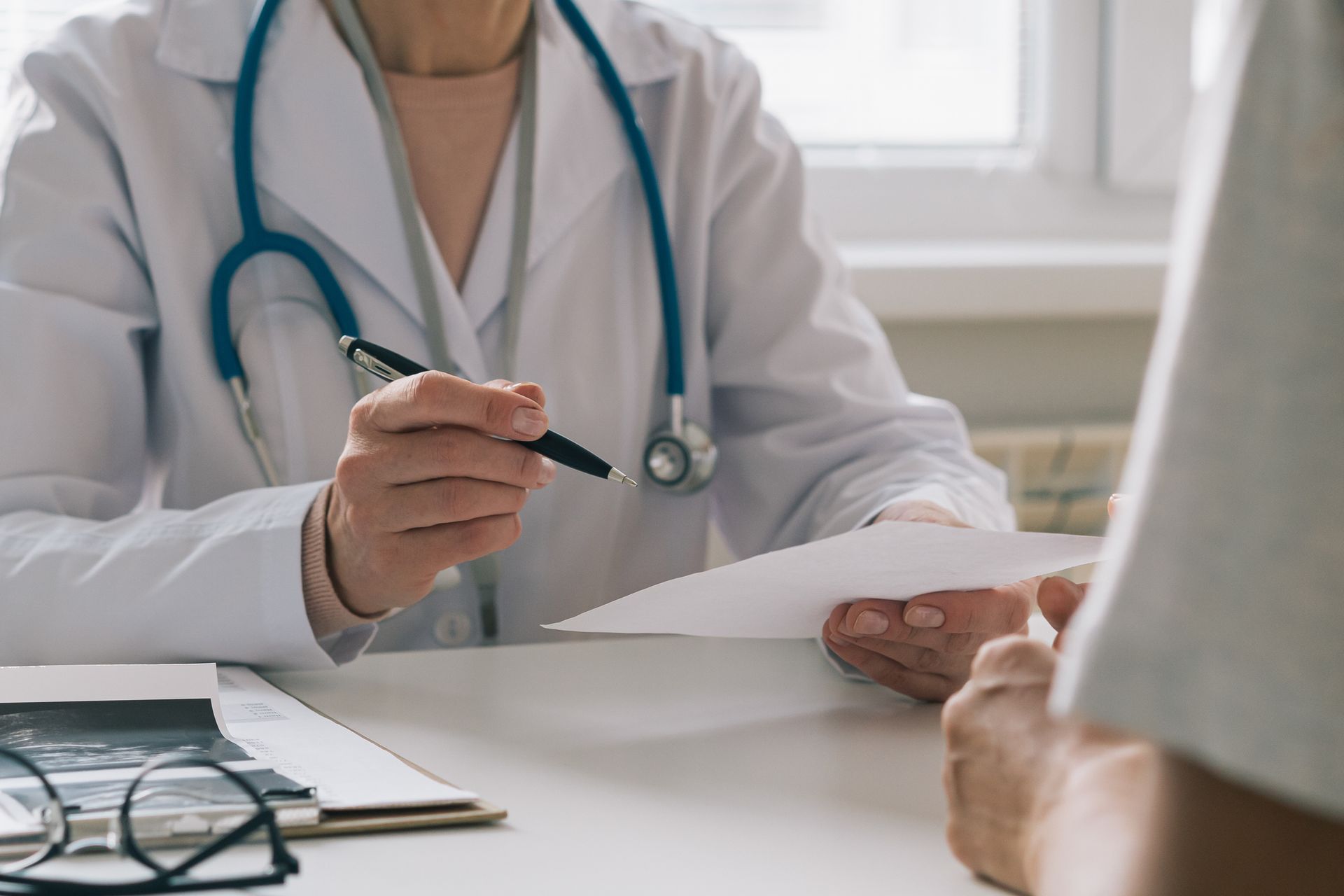 Doctor Writing — Harrisonville, MO — Fast Comprehensive Care