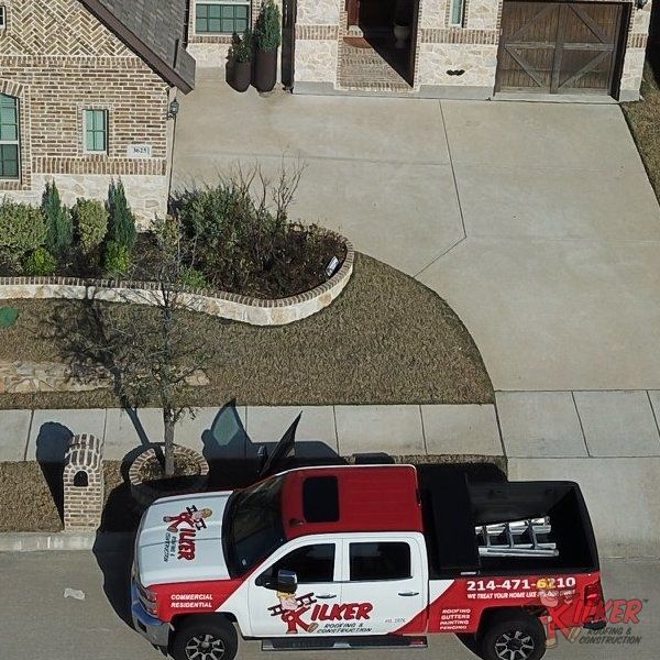 A red and white truck with the word ilker on it