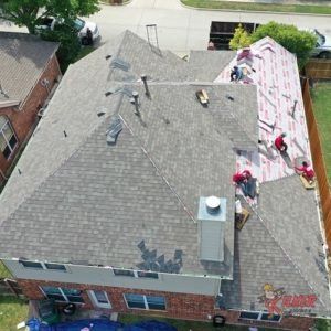 An aerial view of a roof being installed on a house.