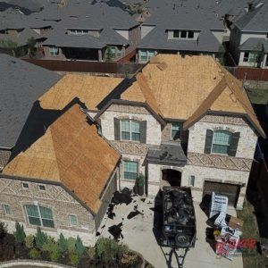 An aerial view of a large house with a trailer parked in front of it.