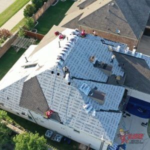 An aerial view of a roof being installed on a house.