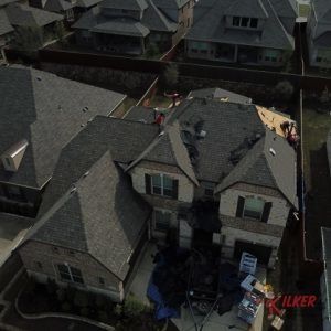 An aerial view of a residential neighborhood with a house in the middle