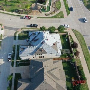An aerial view of a house with a roof that is being repaired