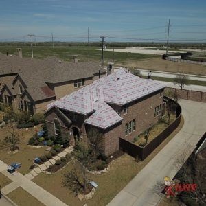 An aerial view of a house with a roof covered in shingles.