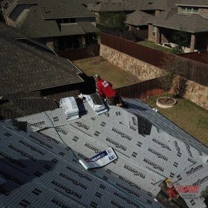 A man is working on the roof of a house.