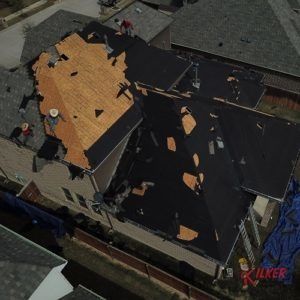 An aerial view of a house being remodeled with a new roof.