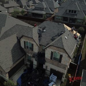 An aerial view of a house with a roof being repaired.