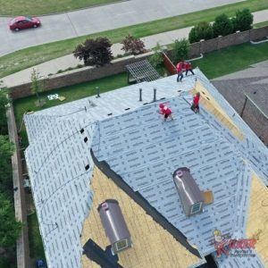 An aerial view of a roof being installed on a house.