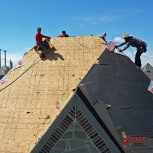 A group of people are working on a roof.