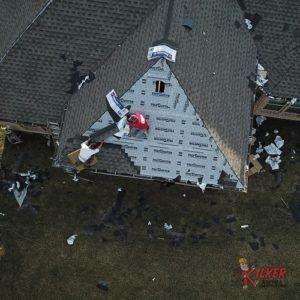 An aerial view of a roof being installed on a house