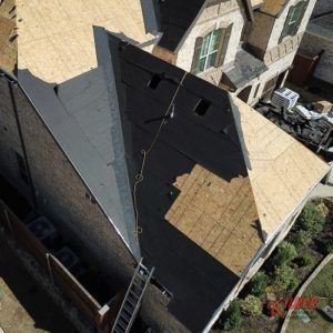 An aerial view of a house with a ladder attached to it.