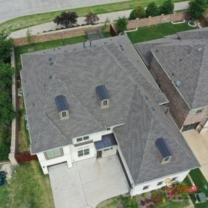 An aerial view of a house with a gray roof.
