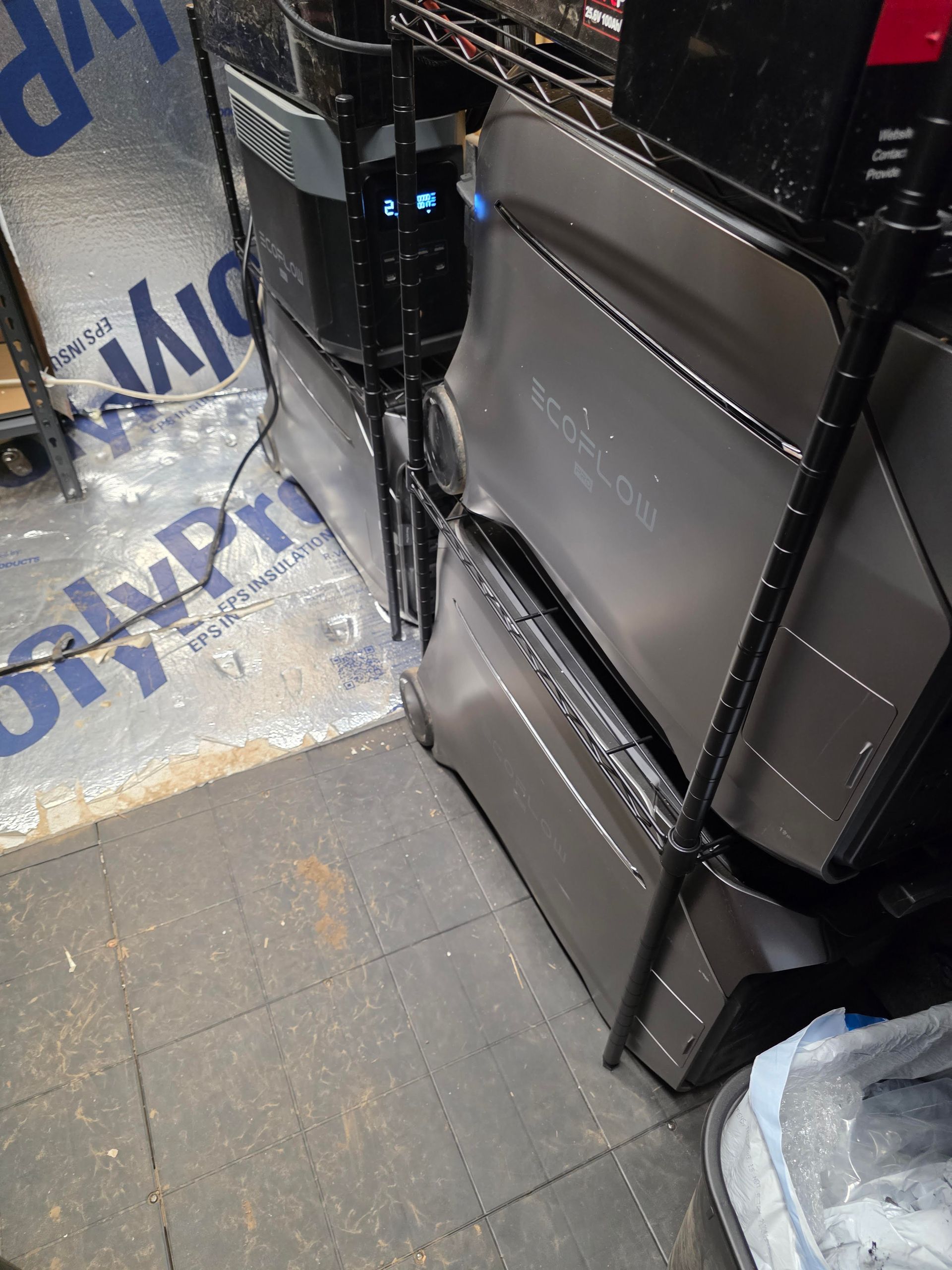 Black padded chairs beside a glass counter on a tiled floor in a narrow indoor space