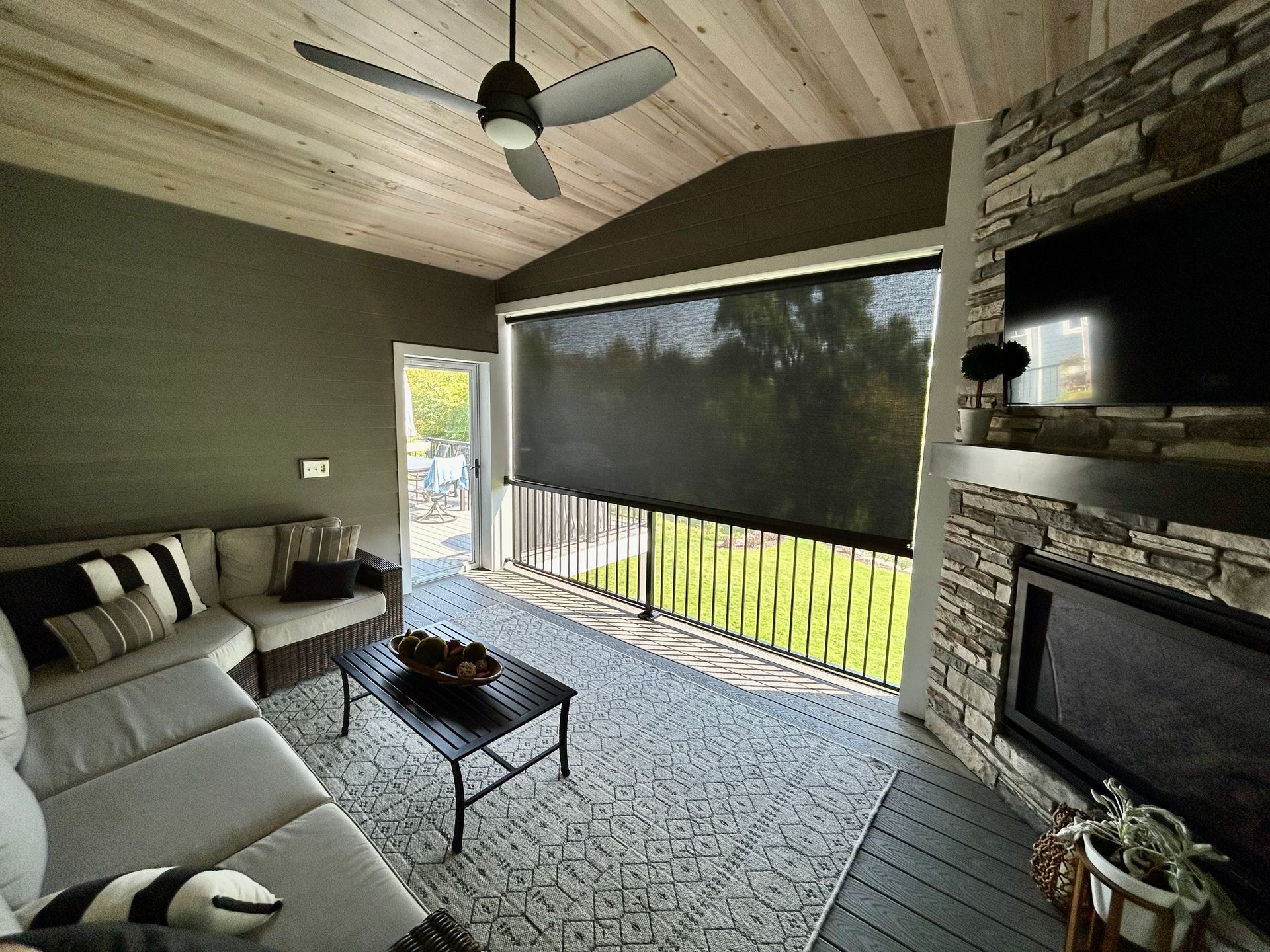 A screened in porch with a view of the ocean.