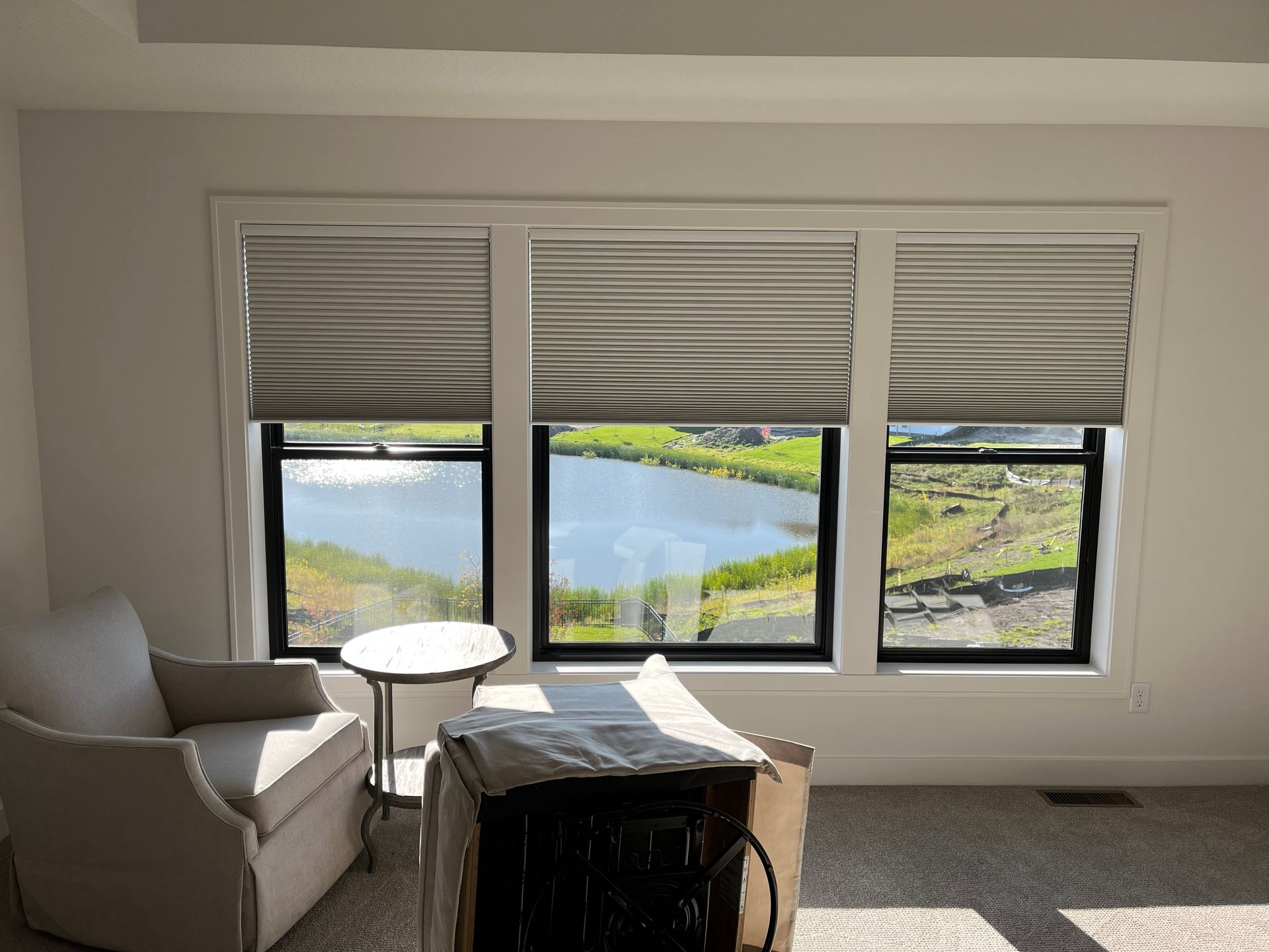 There is a large window with a view of a lake.